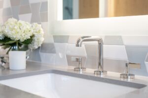 stainless sink primary bathroom white flowers in vase