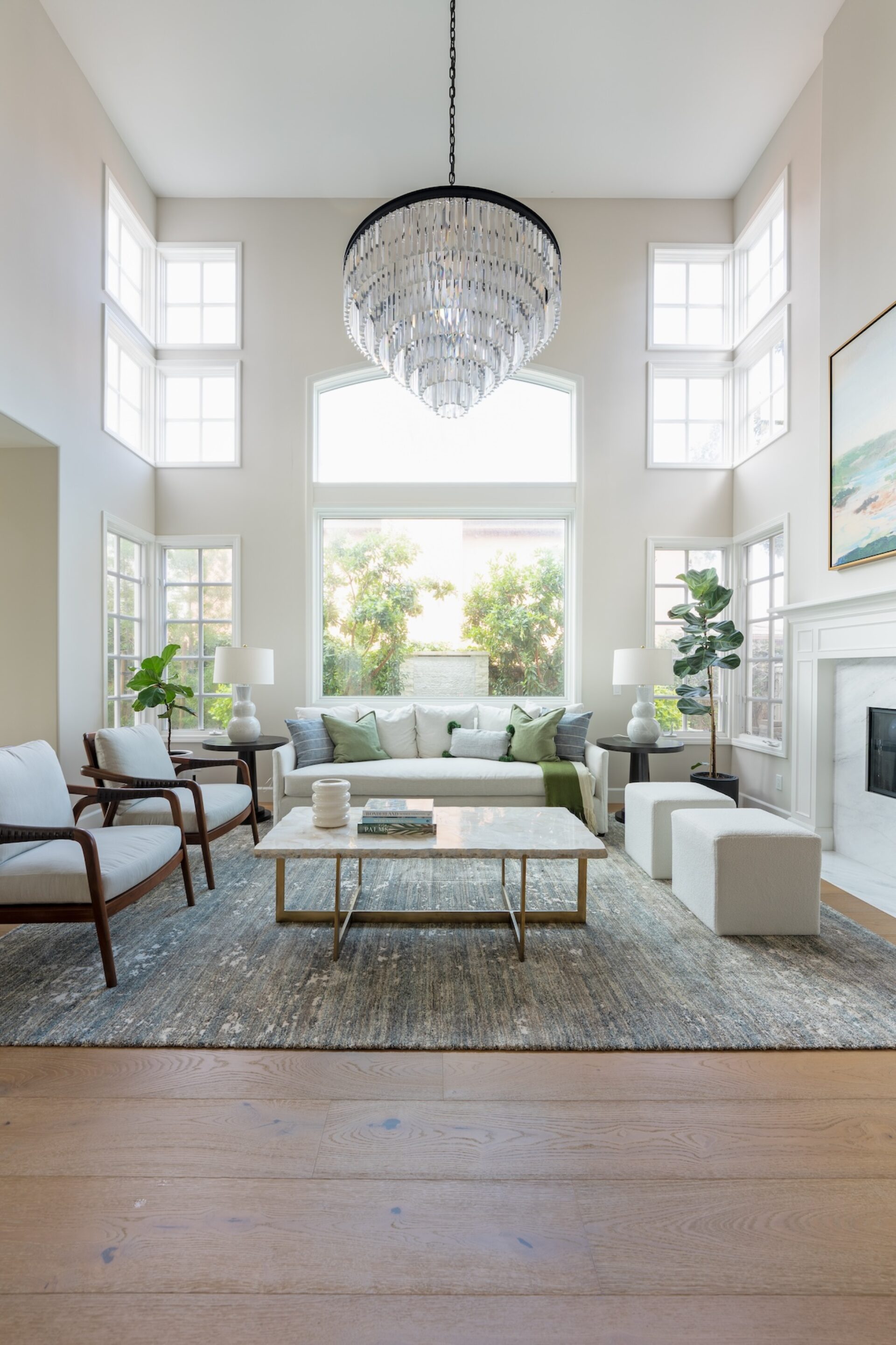 Living Room With Tall Ceilings And Large Chandelier