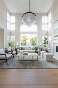 Living Room With Tall Ceilings And Large Chandelier