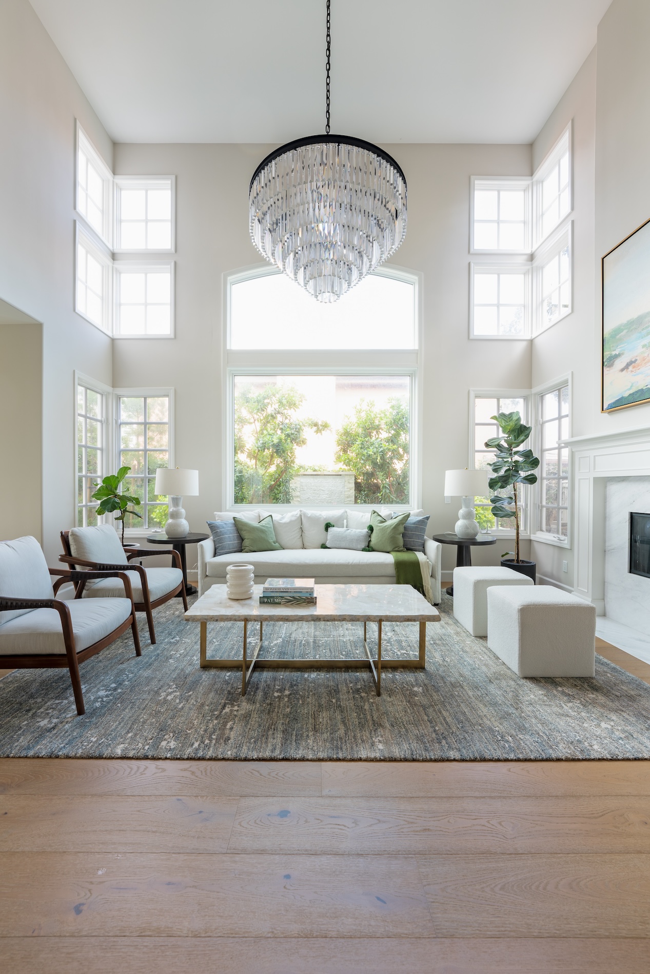 Living Room With Tall Ceilings And Large Chandelier