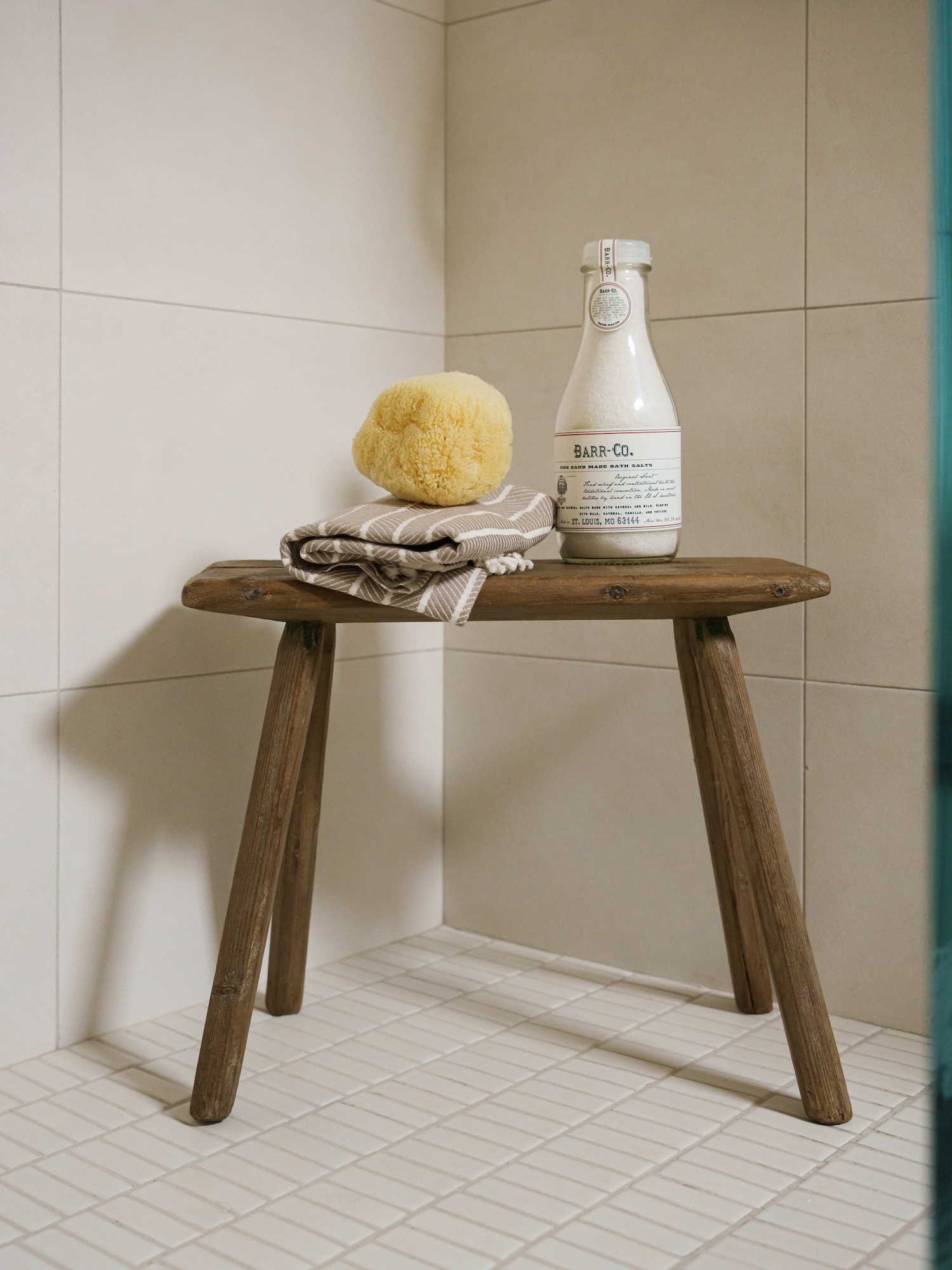 Small Wooden Stool In White Tile Shower